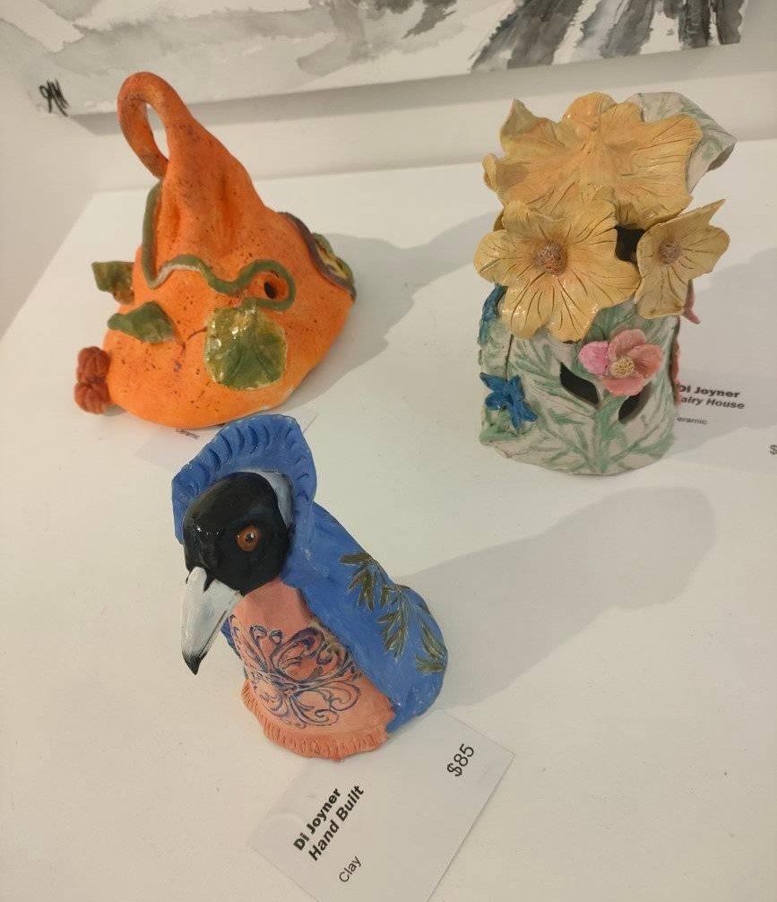 Figurines and Objects, at Dayboro Art Gallery 3 Three clay figurines including a pumpkin hat, crow and flower vase