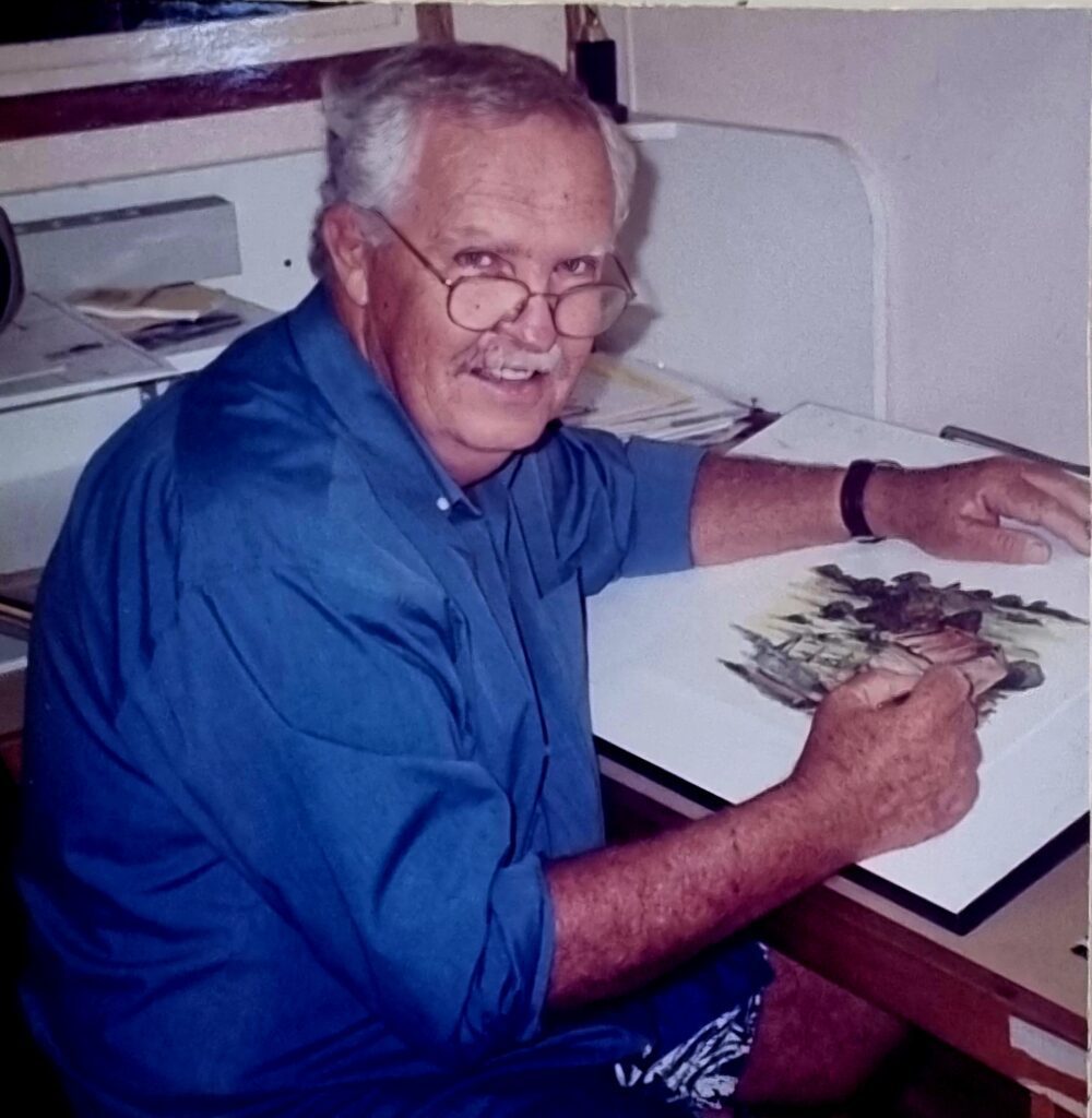Mac Vines Retrospective, Dayboro Open Night 2025 1 man in a blue shirt sitting at his drawing desk